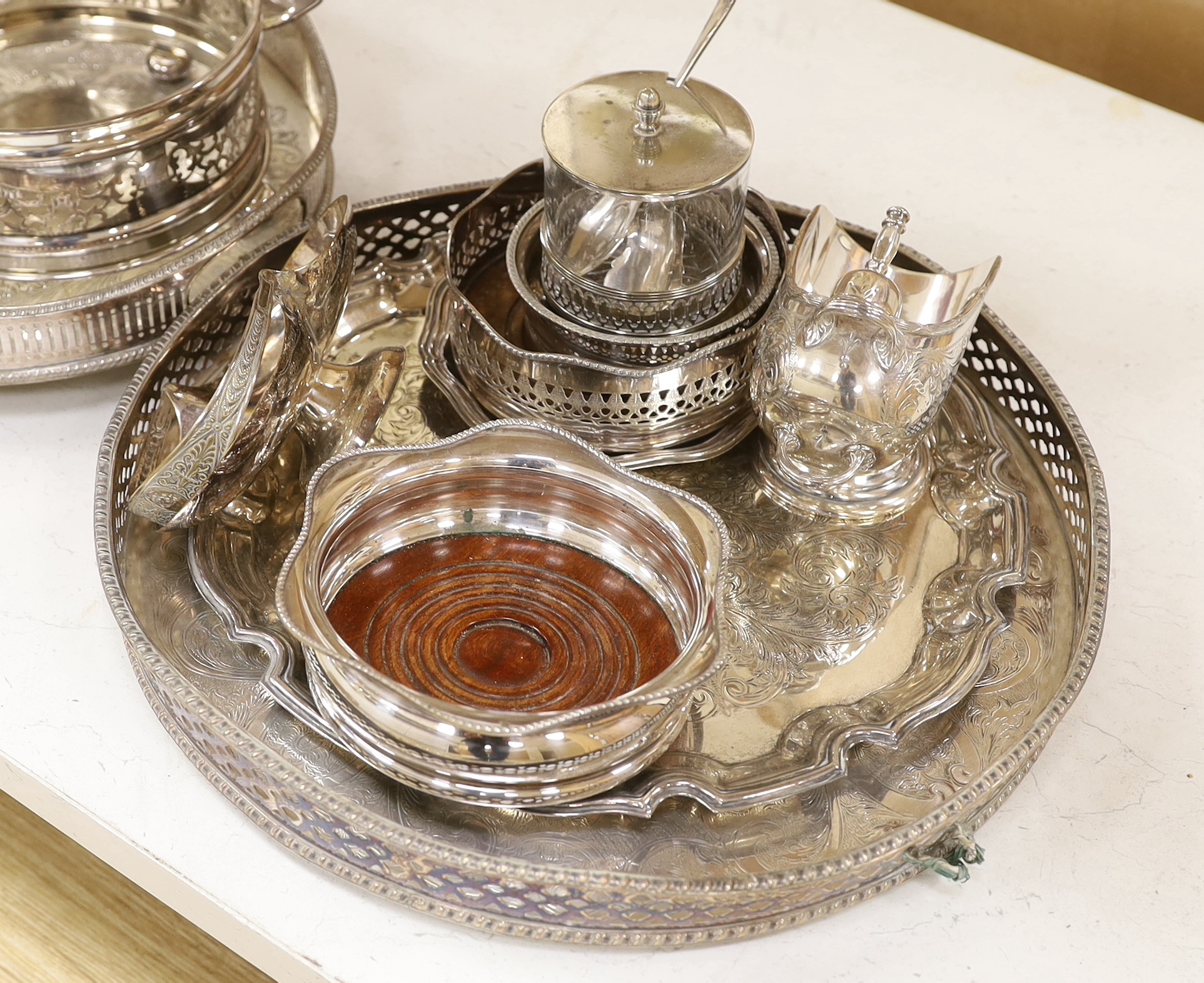 A quantity of silver plate including two trays with pierced galleries, a wine coaster, condiment serving pots, etc.